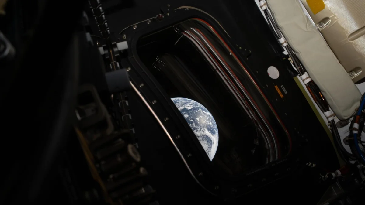 A second, shorter-exposure photograph of Earth from Artemis II showing how dark the nightside appeared to the naked eye, with city lights visible as faint specks (NASA / Reid Wiseman)