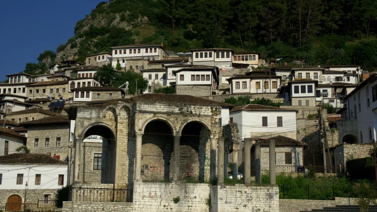 White Ottoman houses climbing a hillside in Berat, Albania — UNESCO old town above the Osum River (Unsplash)