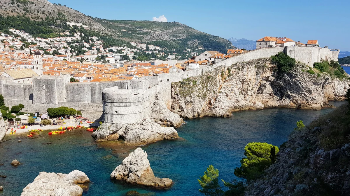 Dubrovnik old town walls above the Adriatic — a benchmark for overtourism that many Balkans destinations still undercut on price (Unsplash)