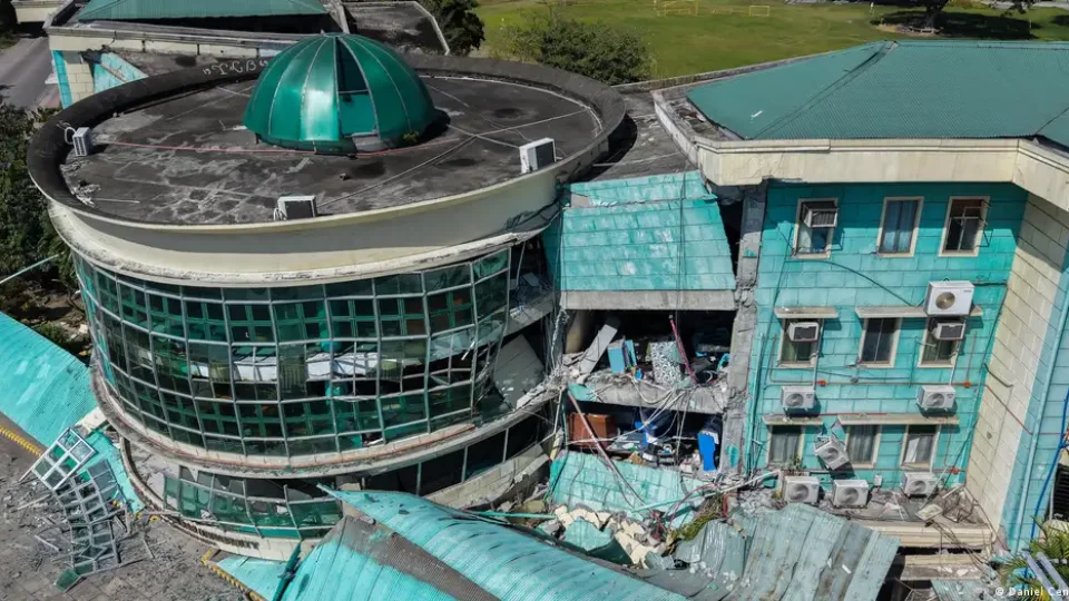 Rescue workers search rubble in General Santos after a magnitude 7.8 earthquake in Mindanao