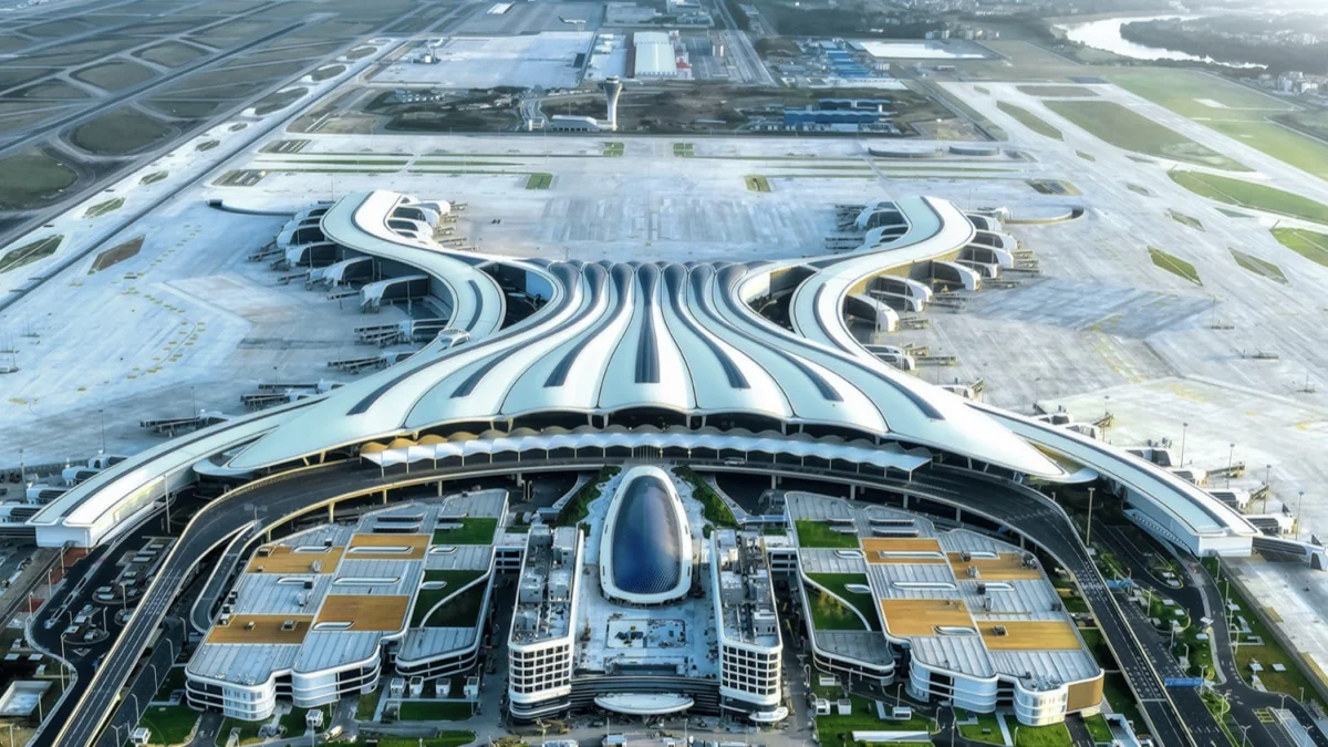 Aerial view of Guangzhou Baiyun International Airport Terminal 3 with curved roof piers radiating from a central courtyard