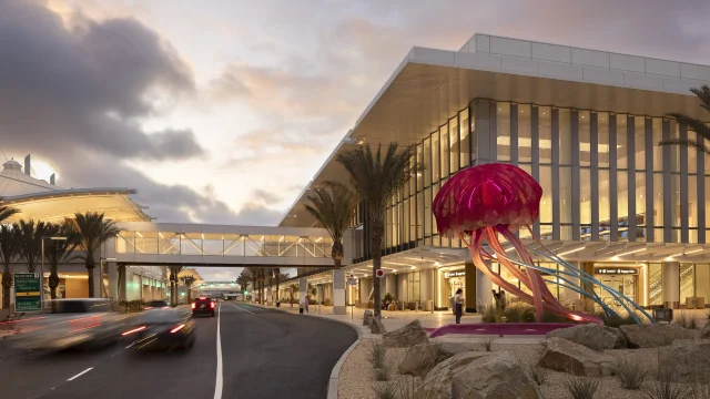 San Diego International Airport Terminal 1 at dusk with a luminous jellyfish sculpture at the kerbside